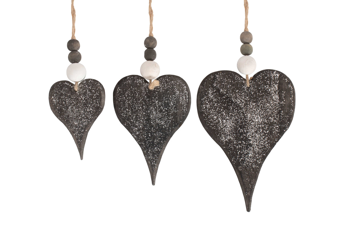 Set of three rustic glitter wooden heart Christmas decorations in graduating sizes with dark weathered finish, wooden beads and natural jute hanging loops