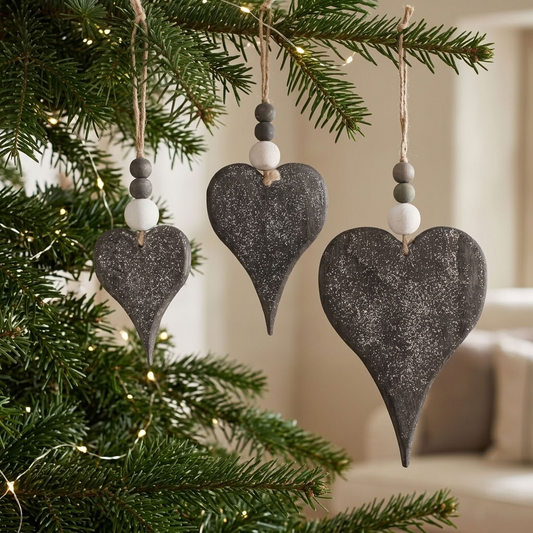Set of 3 Rustic Glitter Wooden Heart Christmas Decorations hanging from evergreen branches with natural wooden beads and jute strings in a country home.