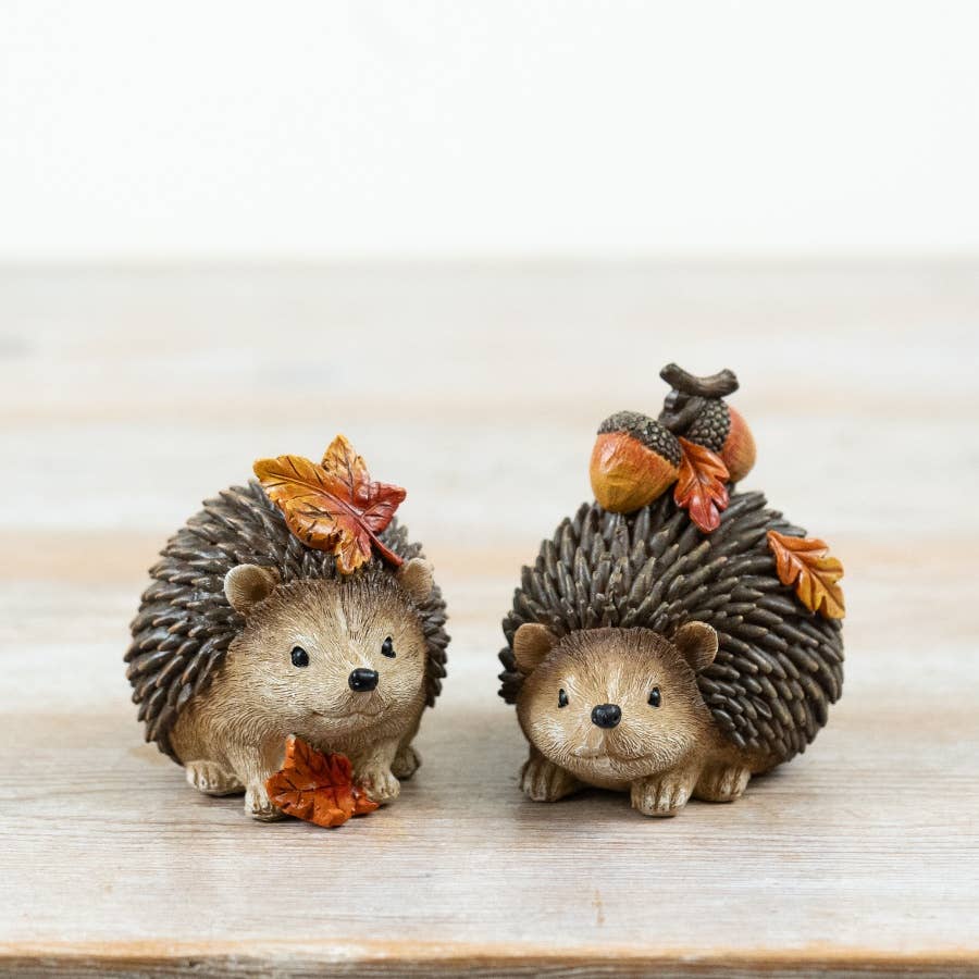 Set of two resin harvest hedgehog decorations with autumn leaves and seasonal details