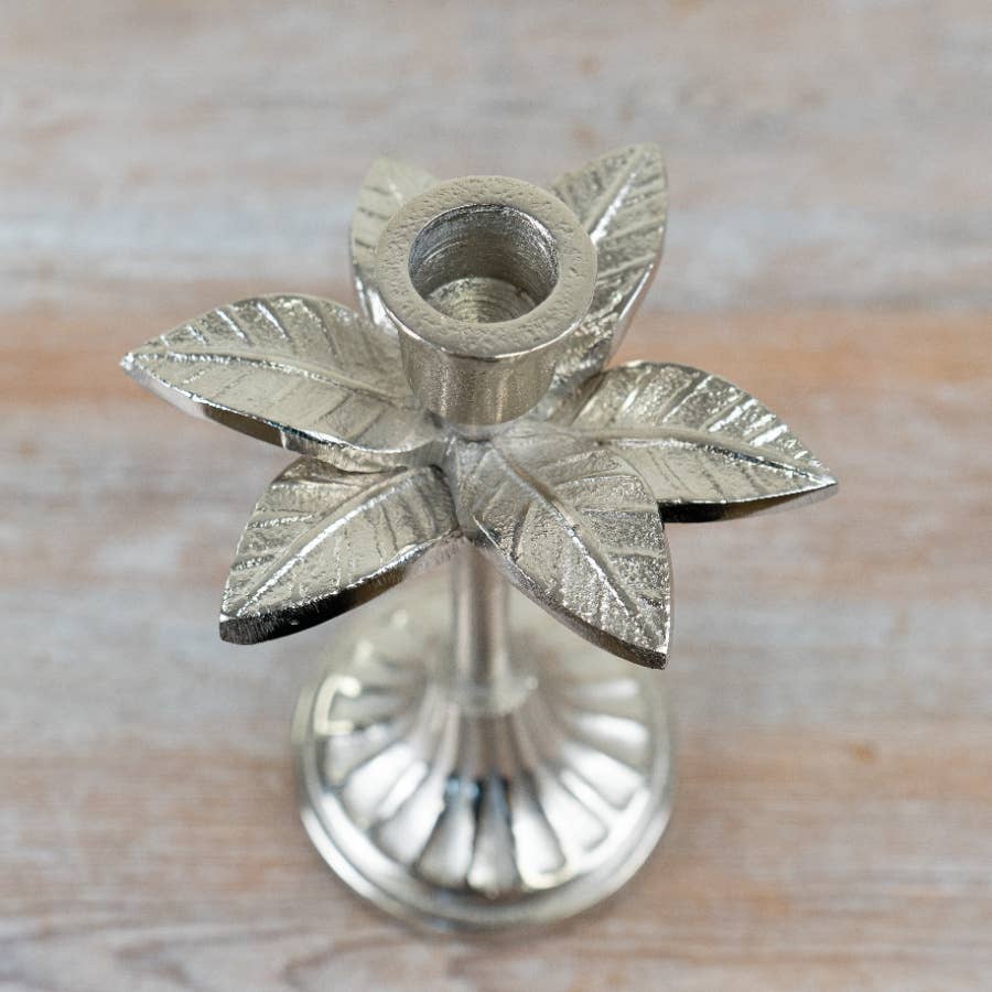 Close-up of sculpted leaf and berry detailing on silver candlestick