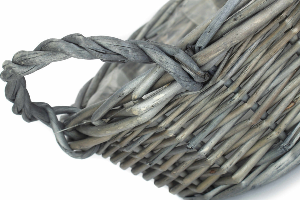 Small round antique wash willow display basket close-up showing the twisted willow handle and rustic woven construction