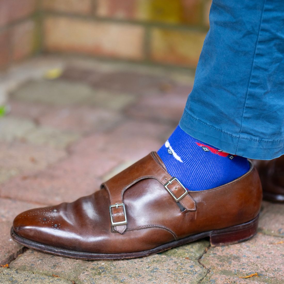 Blue Swole Panda racing car bamboo socks worn with brown shoes