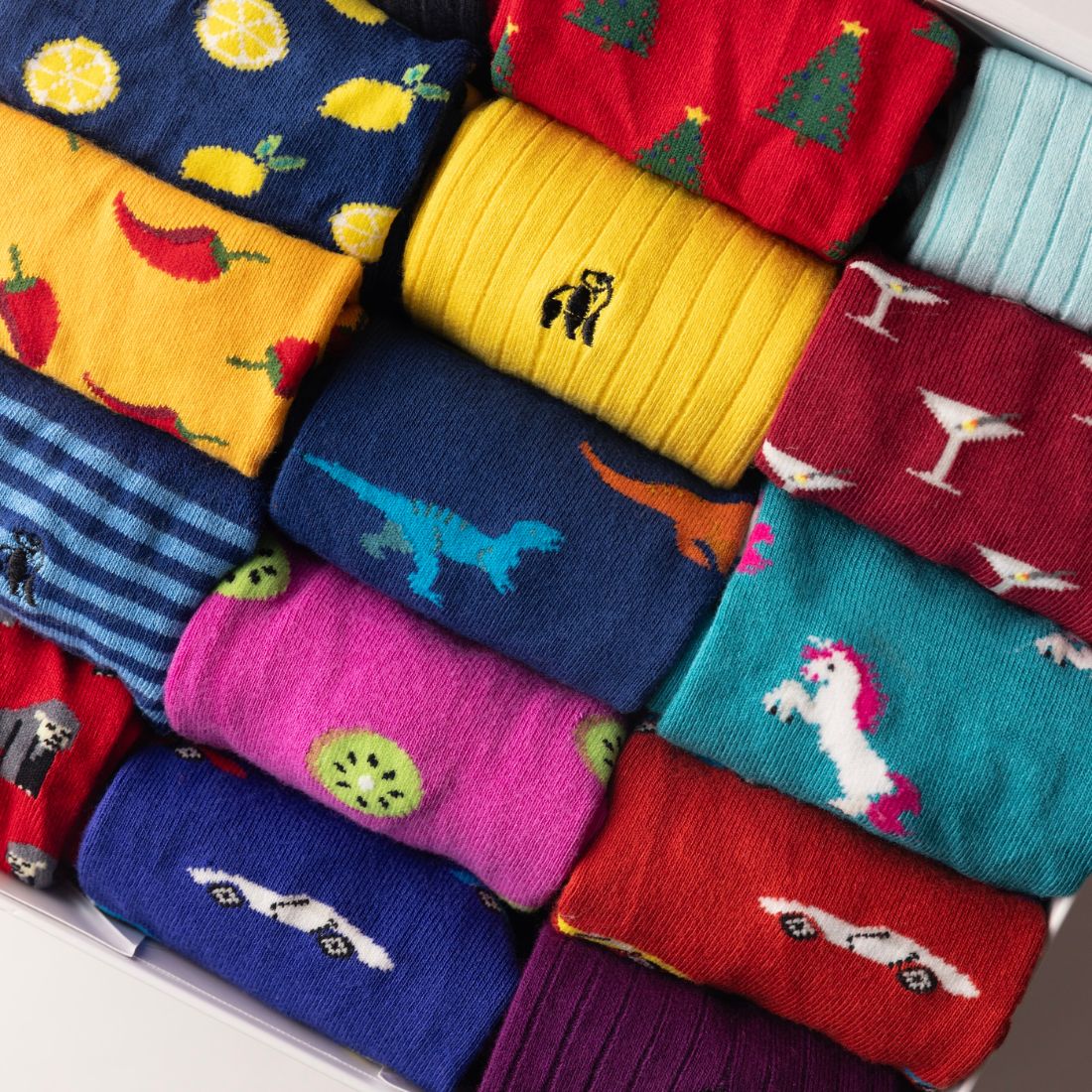 Close-up of brightly coloured Swole Panda bamboo socks with assorted patterned designs