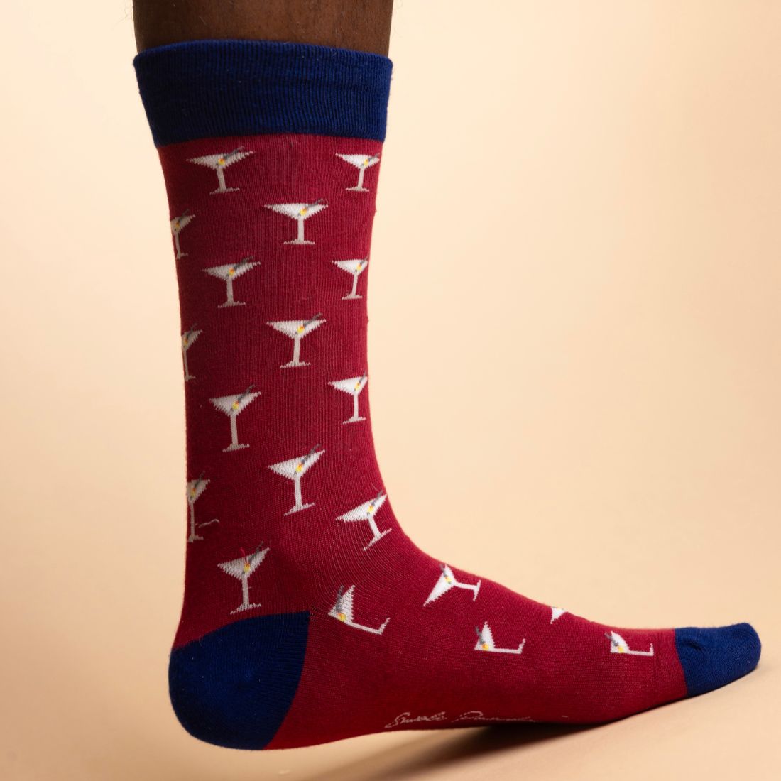 Burgundy Swole Panda bamboo socks with a small repeating pattern and contrasting navy heel and toe