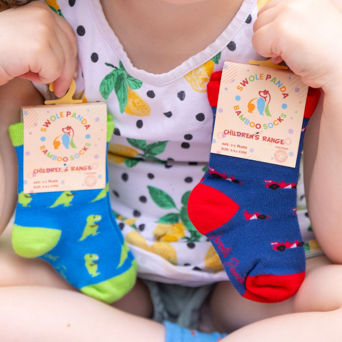 Colourful Swole Panda children's bamboo socks shown in a playful lifestyle setting