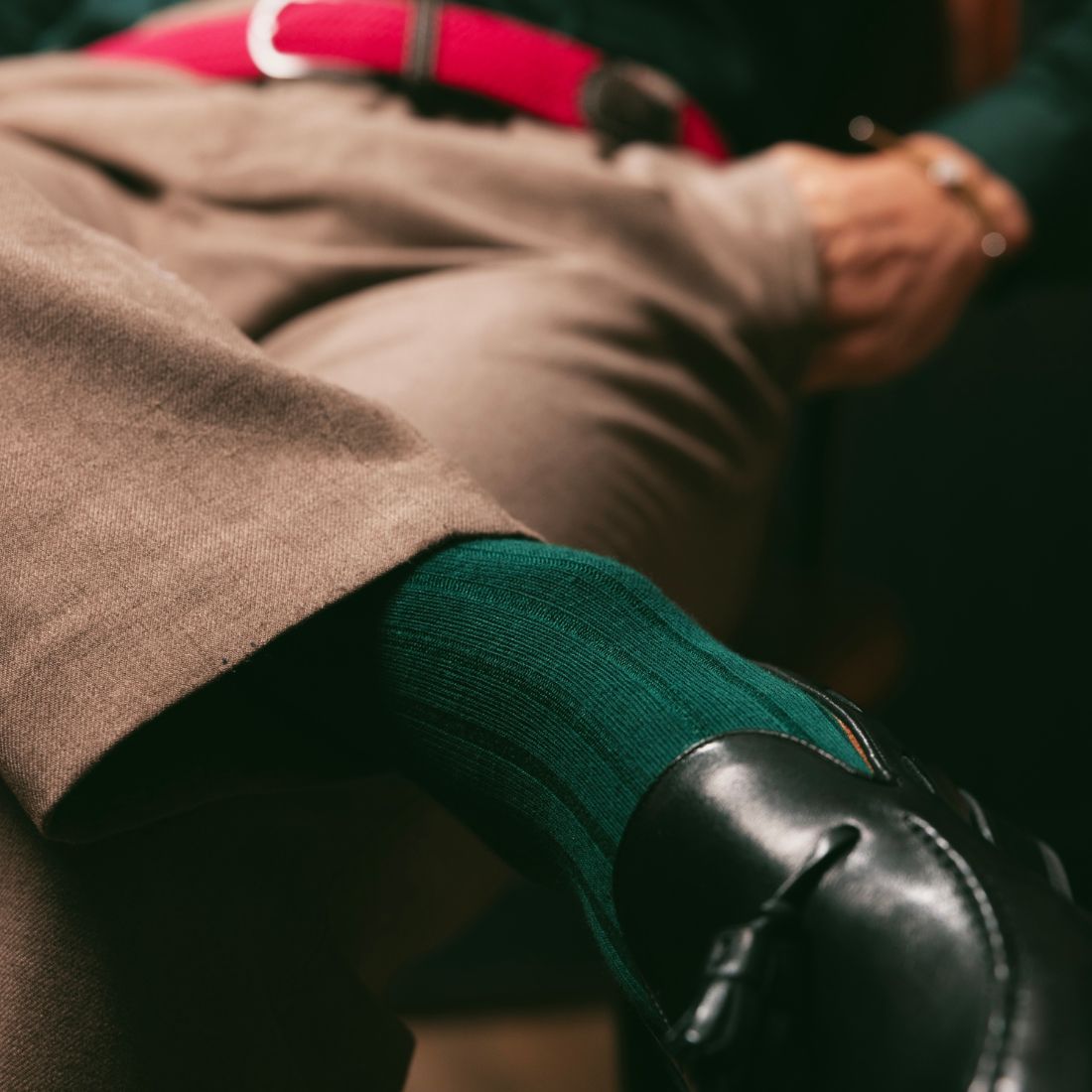 Green Swole Panda bamboo socks worn with smart trousers and shoes