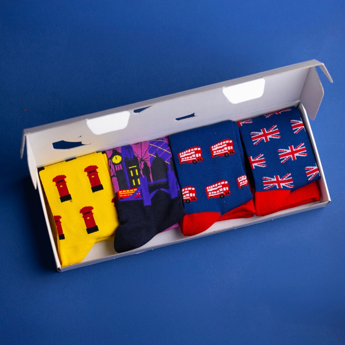Open Swole Panda London Sock Box showing four pairs of colourful bamboo socks