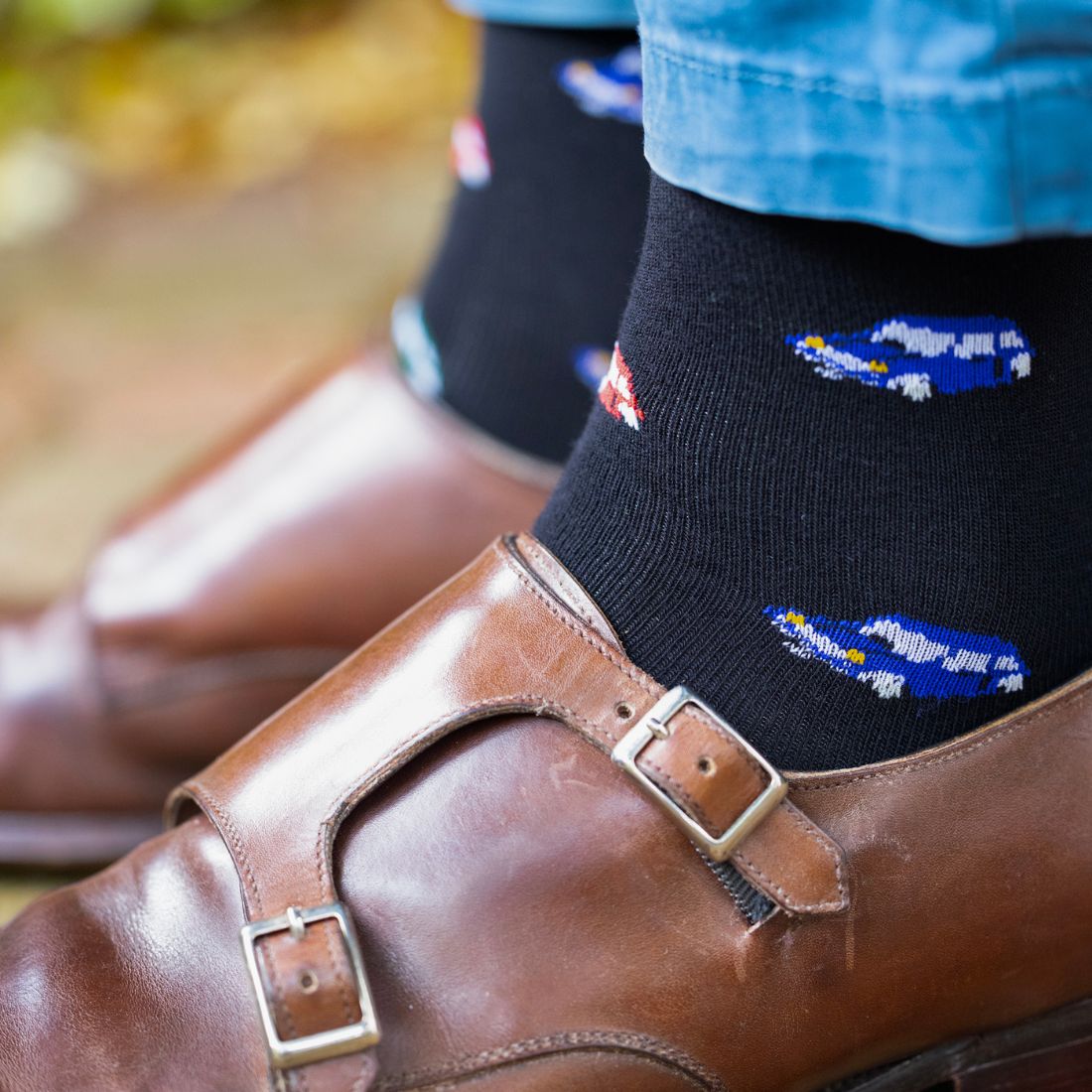 Navy Swole Panda racing car bamboo socks worn with brown shoes