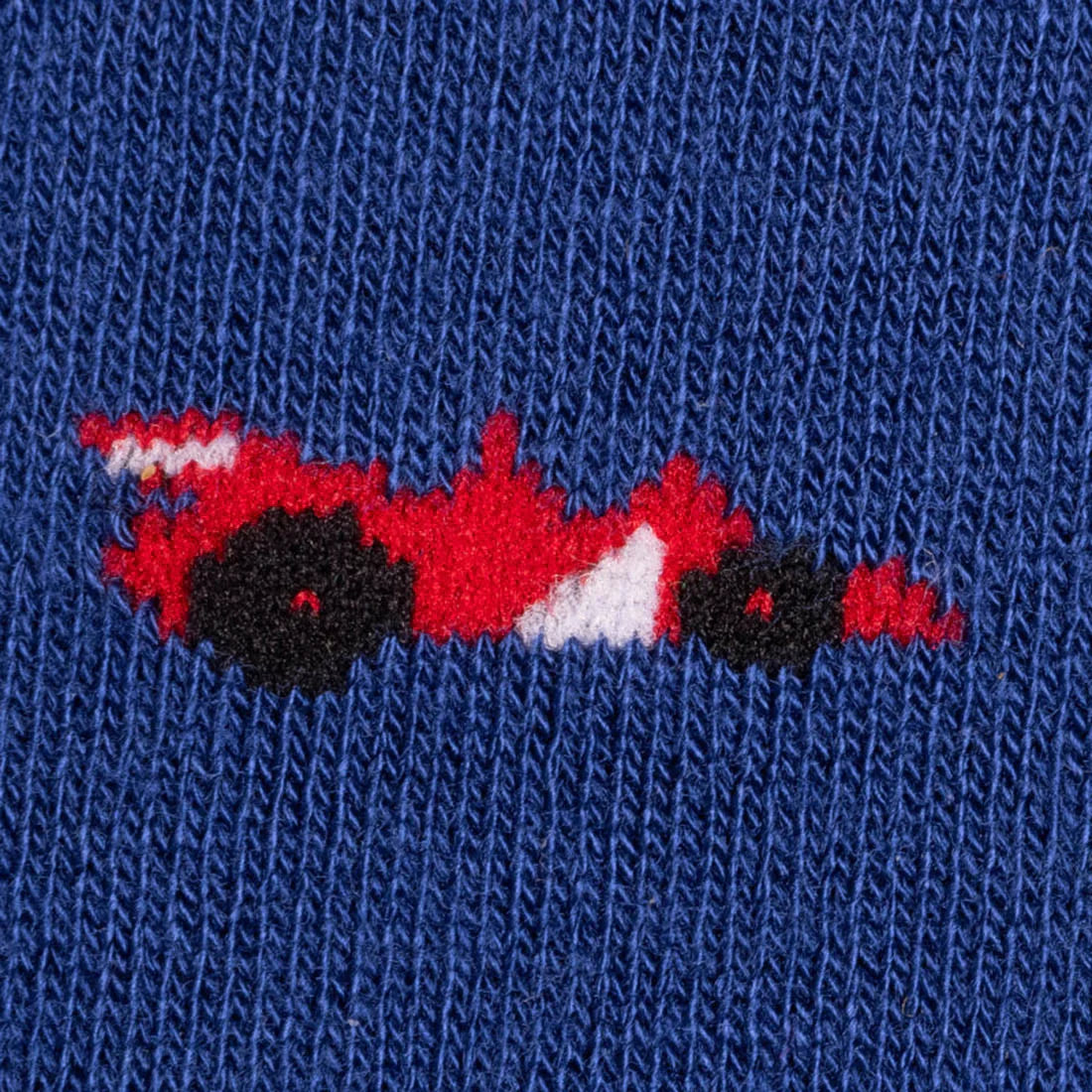 Close-up of the colourful racing car pattern on navy Swole Panda bamboo socks