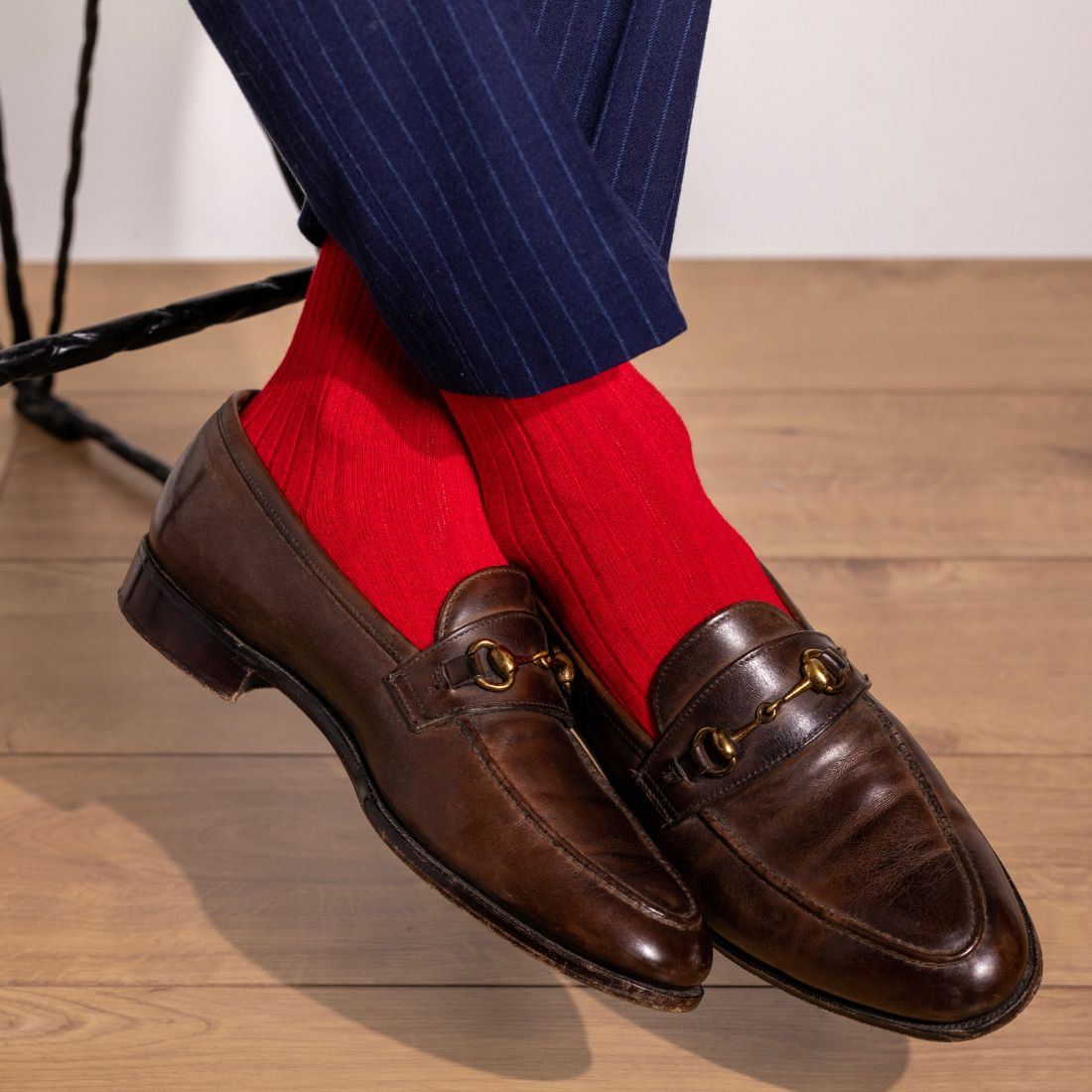 Red Swole Panda bamboo socks worn with navy trousers and brown shoes