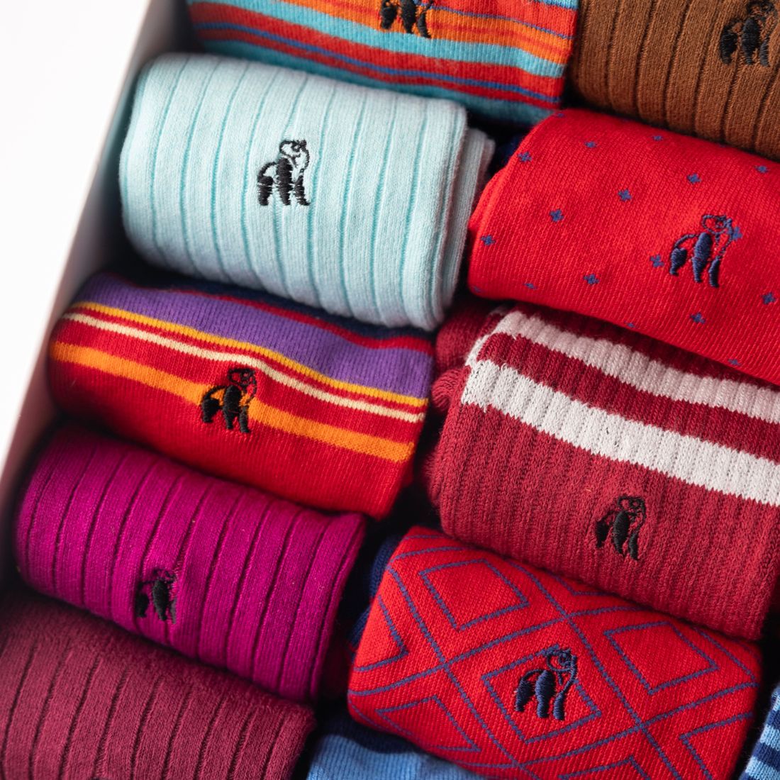 Close-up of red and blue Swole Panda bamboo socks with colourful patterned details