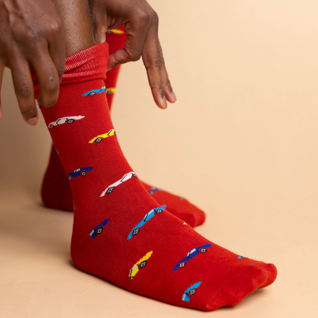 Red Swole Panda bamboo socks featuring a colourful repeating pattern