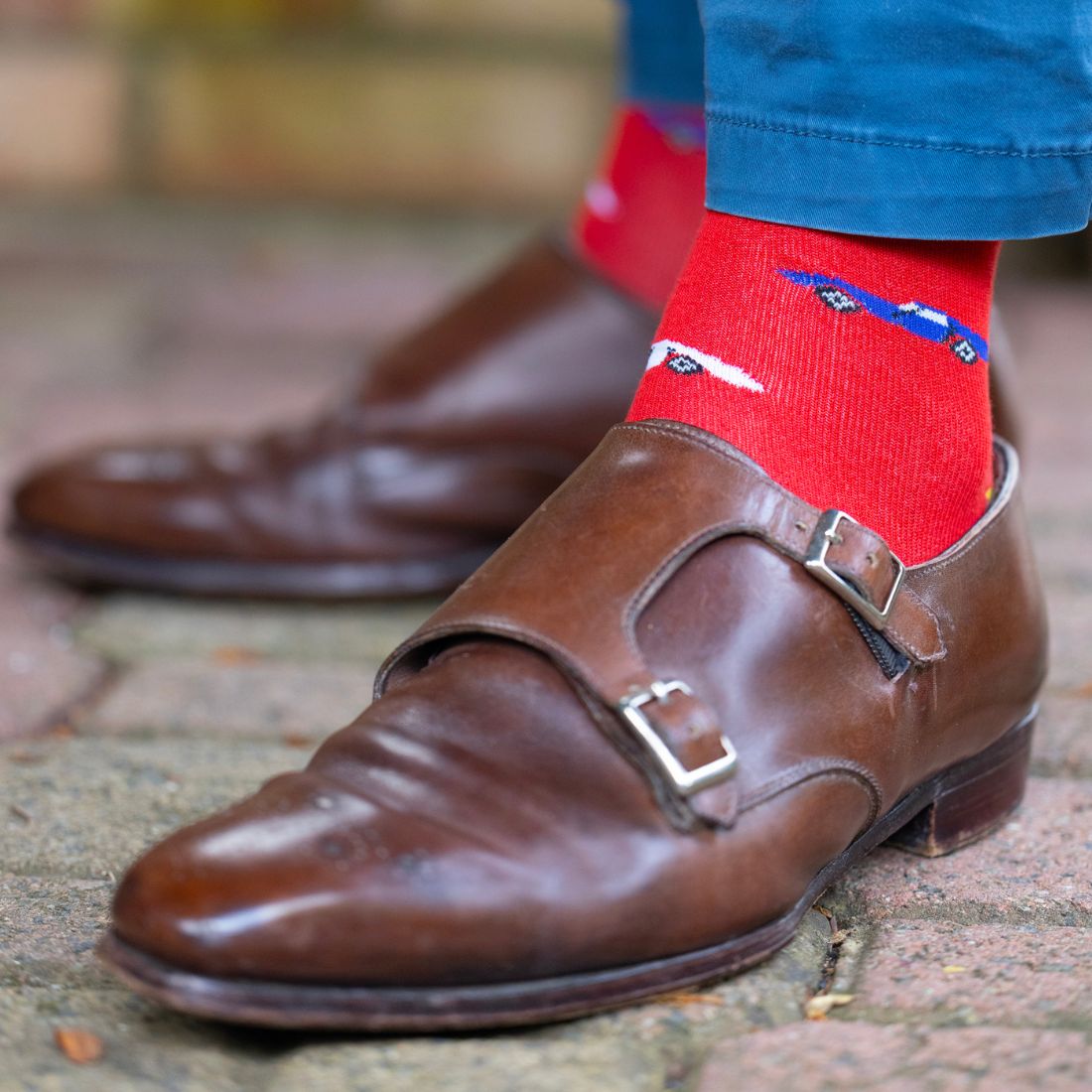 Red Swole Panda racing car bamboo socks worn with brown shoes