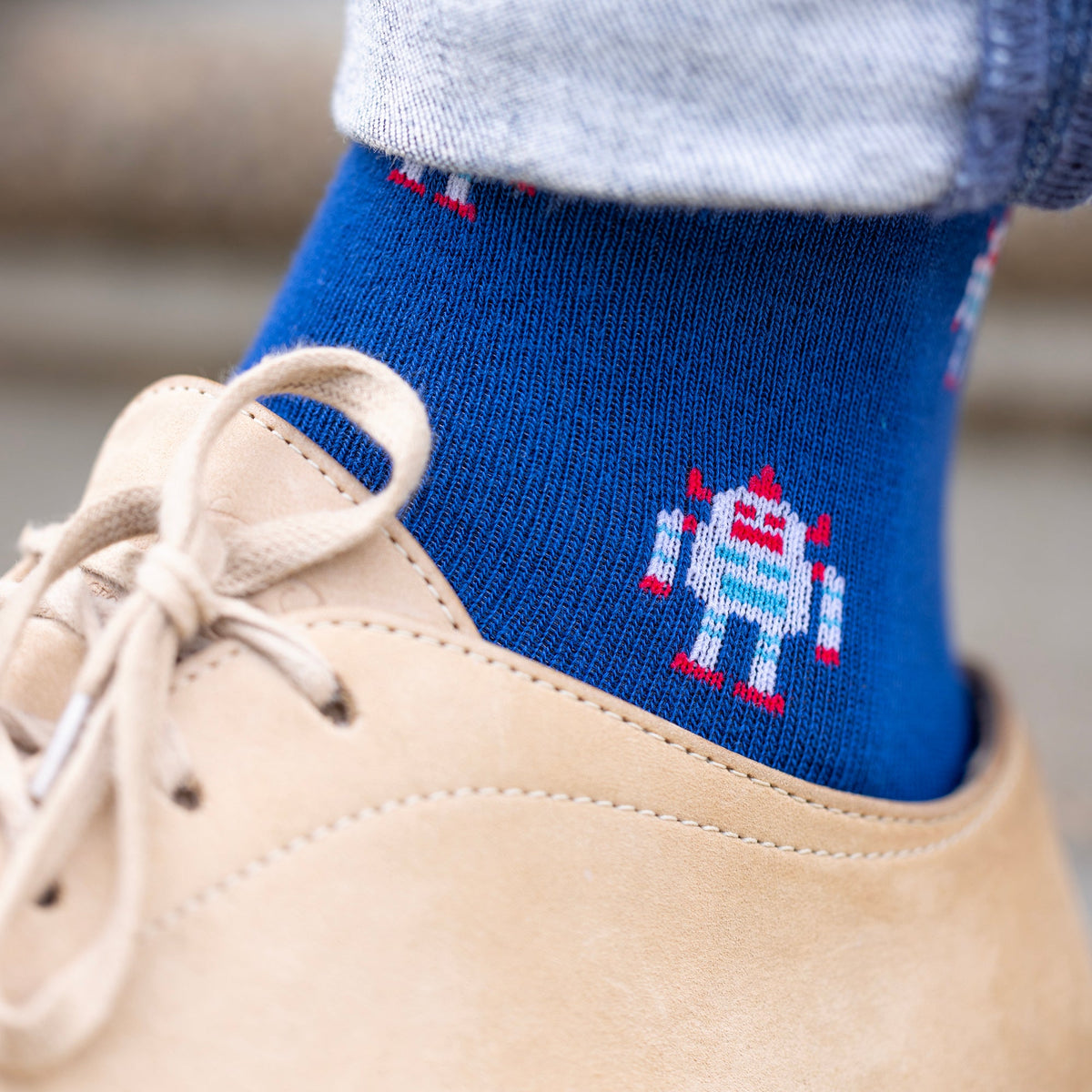 Adult wearing navy Swole Panda Robot bamboo socks with contrasting blue details