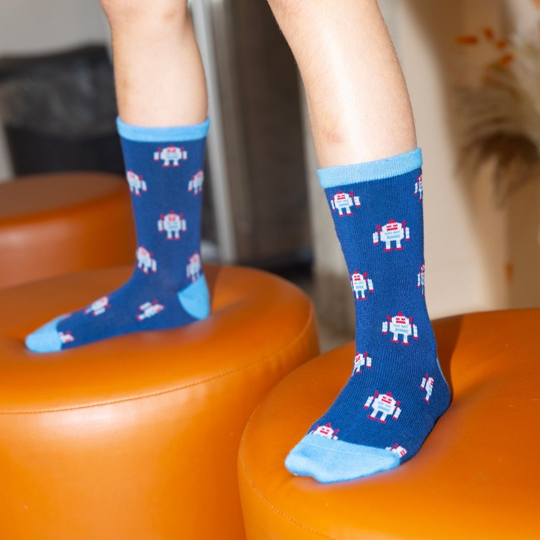 Child wearing navy Swole Panda Robot bamboo socks with contrasting blue details