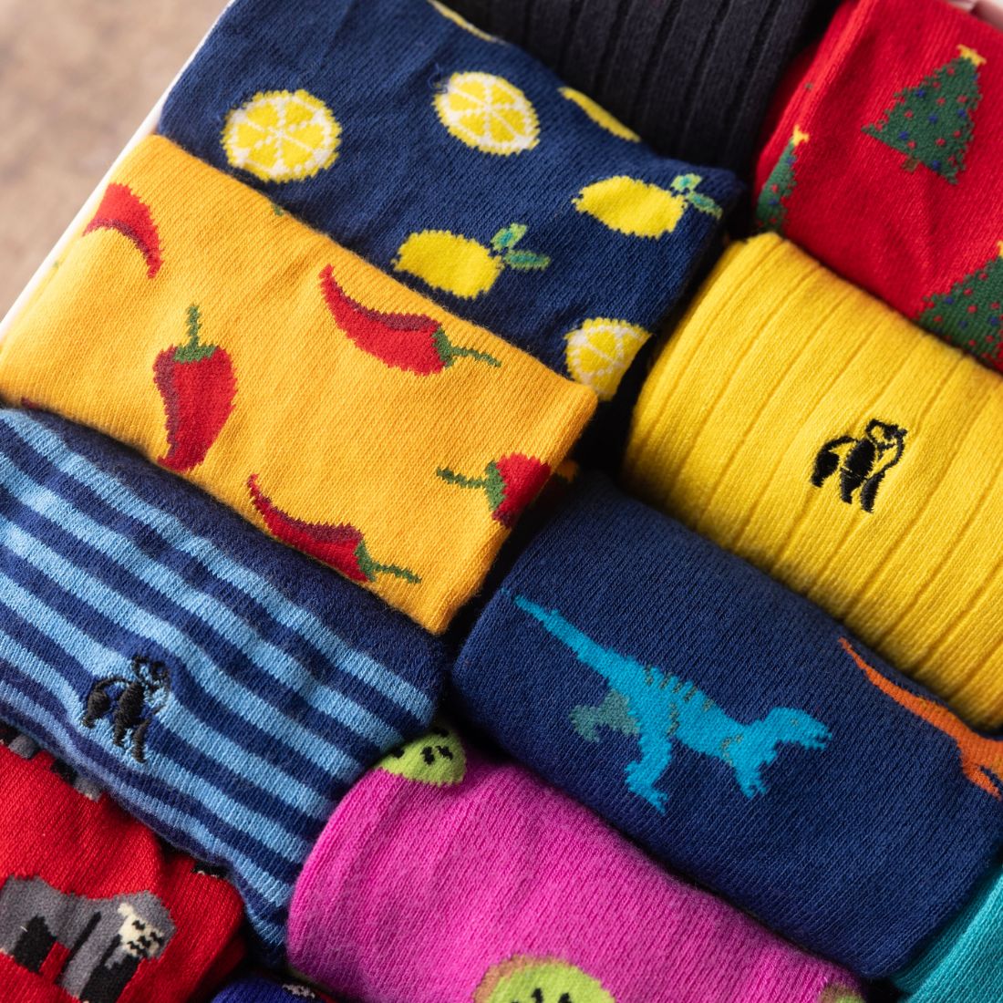 Close-up of yellow, blue and red Swole Panda bamboo socks with assorted patterns