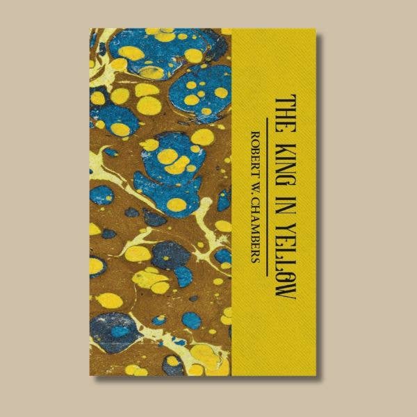 The King in Yellow by Robert W. Chambers, Wordsworth paperback with yellow title panel and decorative blue and gold marbled cover