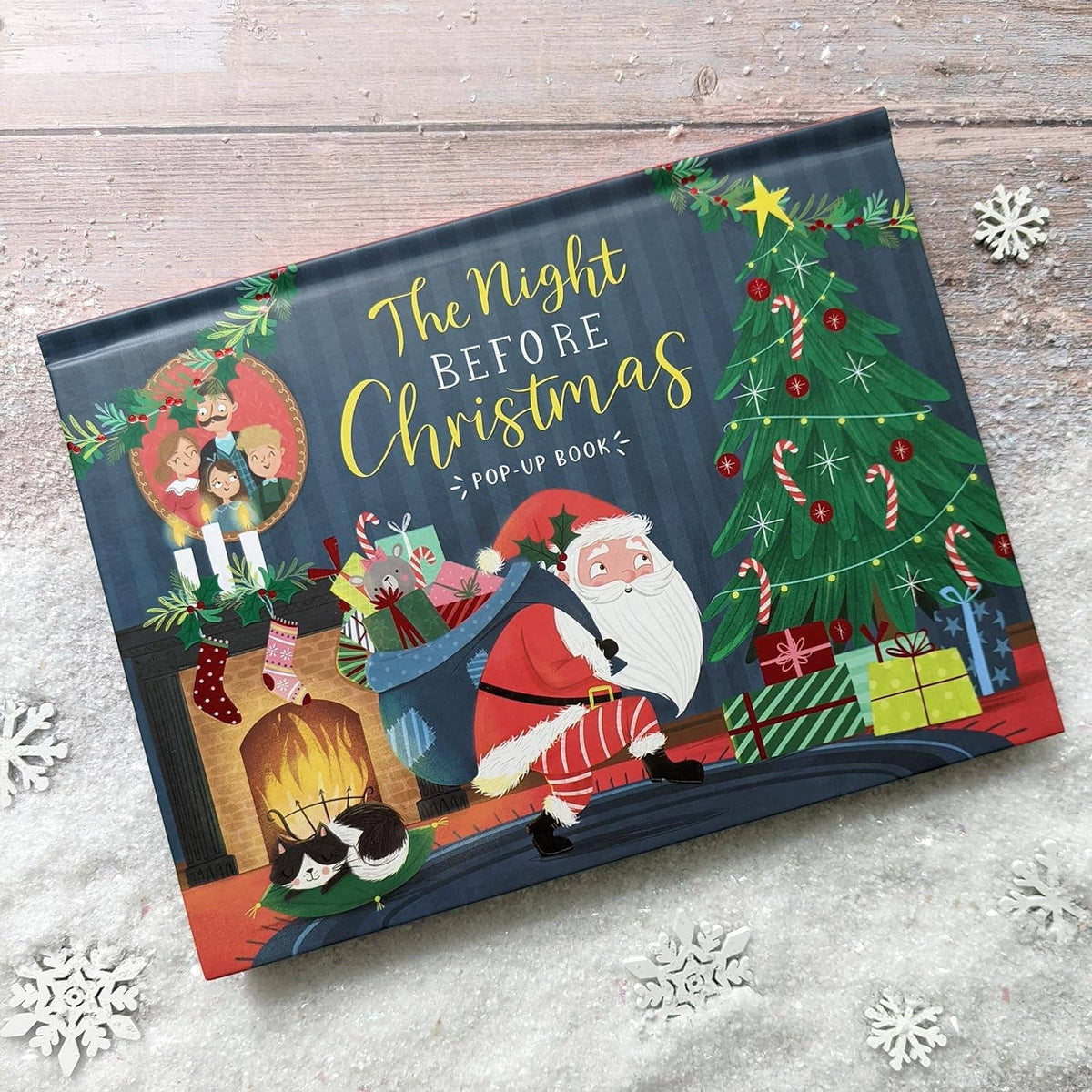 The Night Before Christmas children's pop-up book photographed at an angle showing the illustrated cover