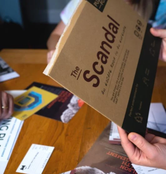 The Scandal Escape Room in an Envelope being played with tennis-themed puzzle clues