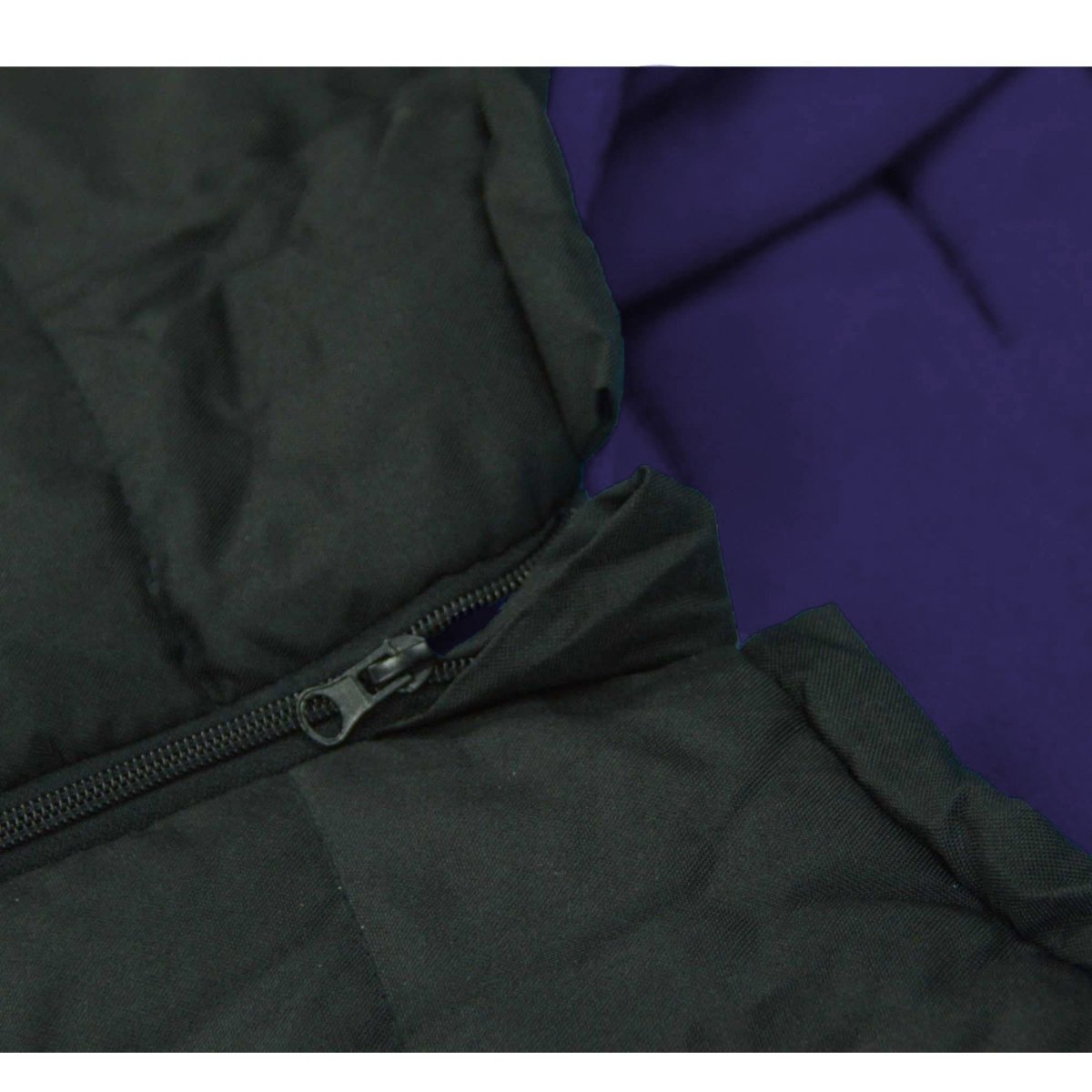Close-up of a black footmuff with a zipper against a purple background