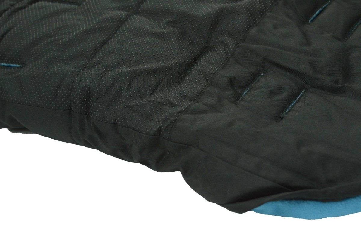 Close-up of a black quilted footmuff with blue lining on a white background