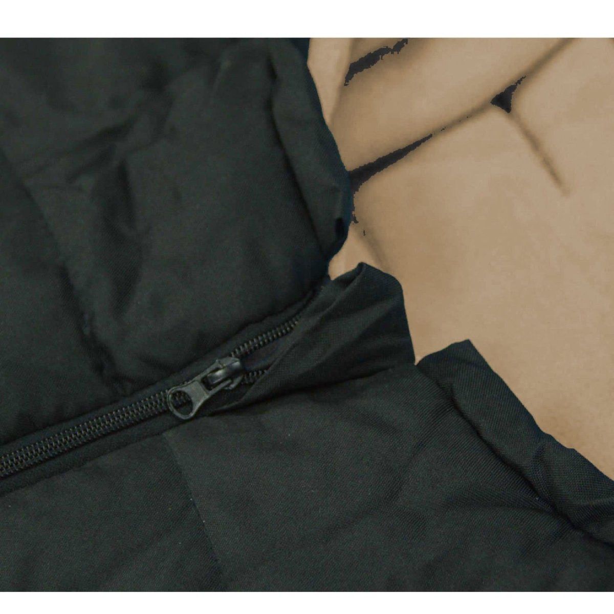Black footmuff with a zipper on a neutral background