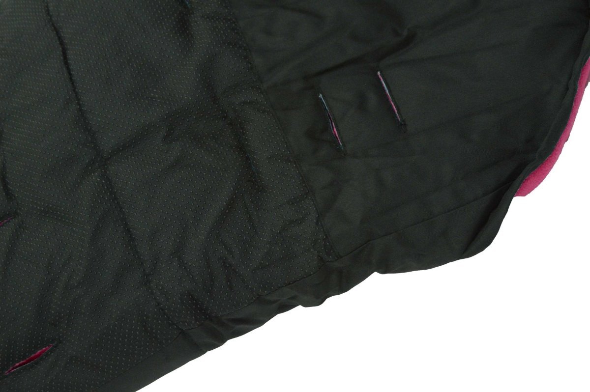 Close-up of a black quilted footmuff with a white background