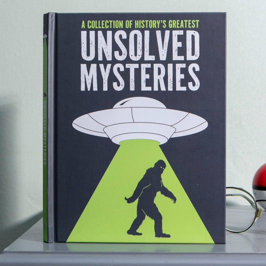 A Collection of History's Greatest Unsolved Mysteries hardback book with dark cover featuring a UFO and Bigfoot illustration.