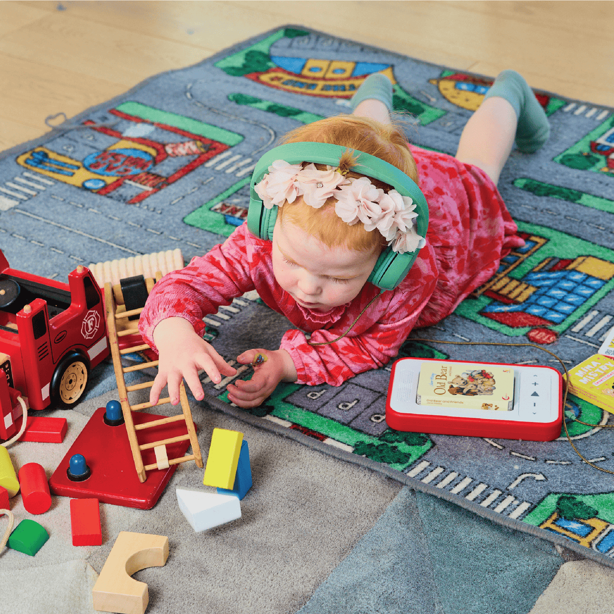 Child enjoying screen-free story time with Voxblock audiobook player and book