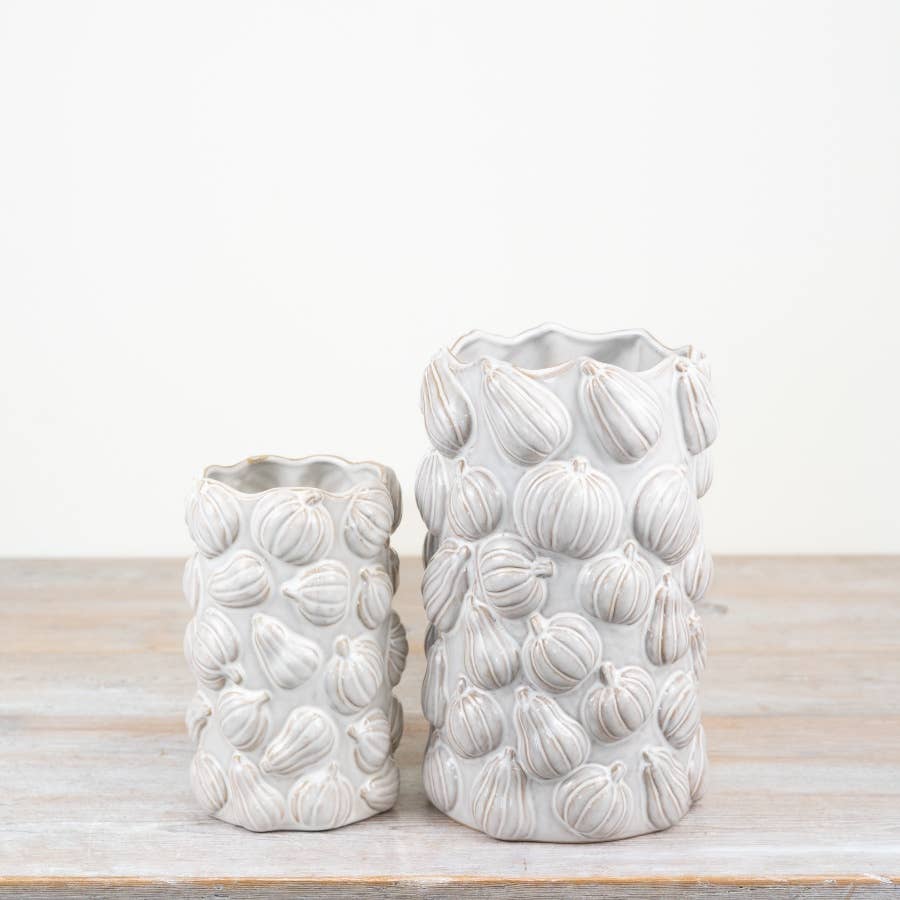 White pumpkin ceramic vase styled as part of a neutral autumn home display
