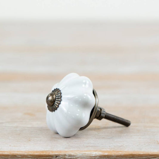 White scalloped ceramic door knob with antique-style metal fitting