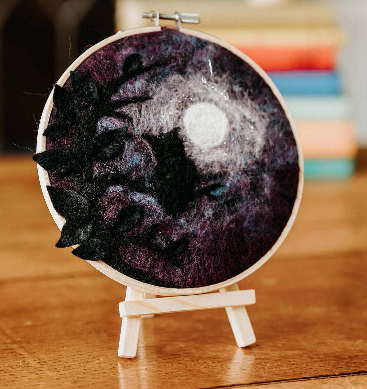 Paint with Wool Wise Old Owl Needle Felting Kit finished owl and full moon artwork displayed on a wooden easel