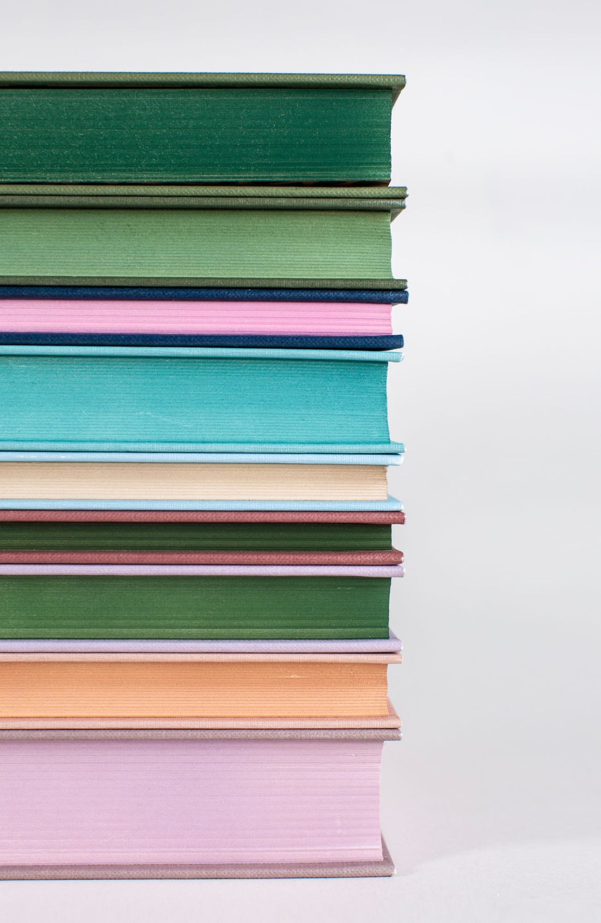 Stack of Wordsworth Luxe Collection hardbacks showing the range of coloured covers and sprayed page edges